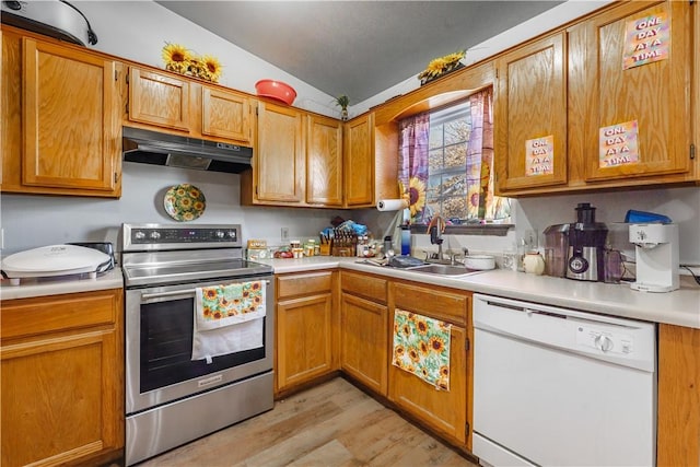 kitchen featuring vaulted ceiling, sink, stainless steel range with electric stovetop, light hardwood / wood-style floors, and white dishwasher