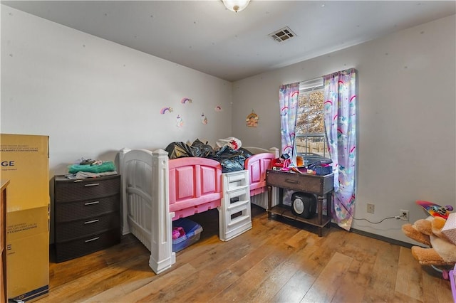 bedroom with hardwood / wood-style flooring