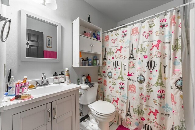 bathroom with vanity, walk in shower, and toilet