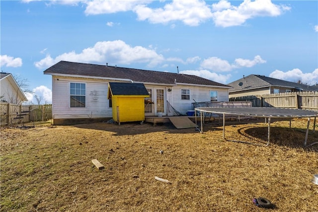 rear view of house with a trampoline