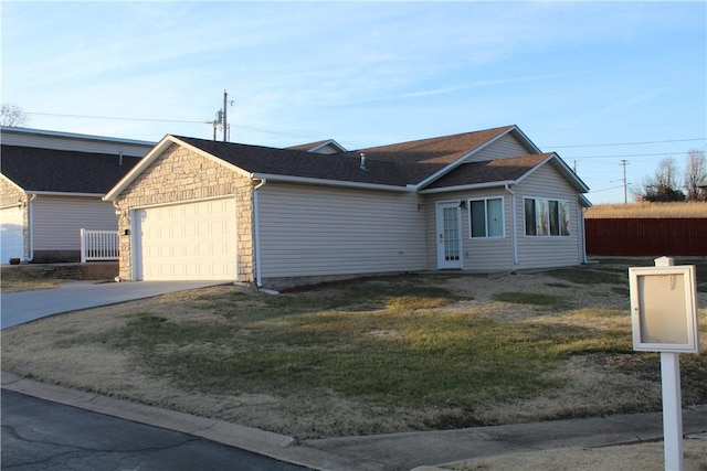 ranch-style home with a garage and a front lawn