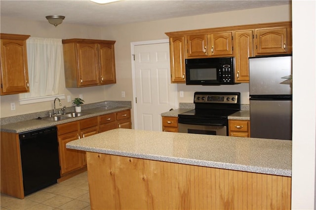 kitchen featuring light tile patterned flooring, sink, and black appliances