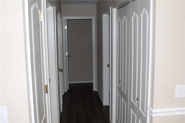 corridor with dark hardwood / wood-style floors