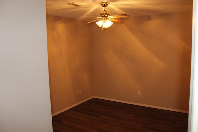 unfurnished room with ceiling fan and dark hardwood / wood-style floors