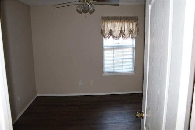 empty room featuring dark wood-type flooring and ceiling fan