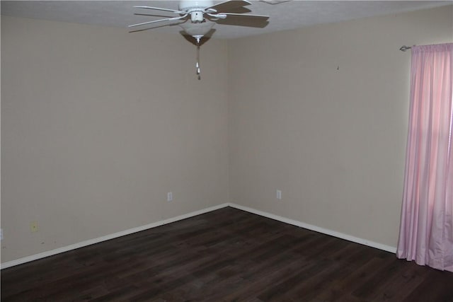 spare room featuring ceiling fan and dark hardwood / wood-style flooring