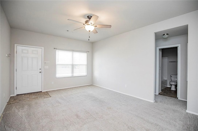 empty room with ceiling fan and carpet