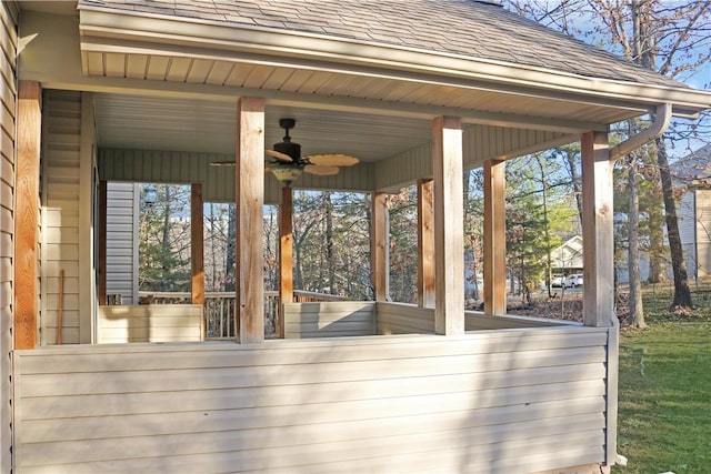 wooden terrace with ceiling fan and a sunroom