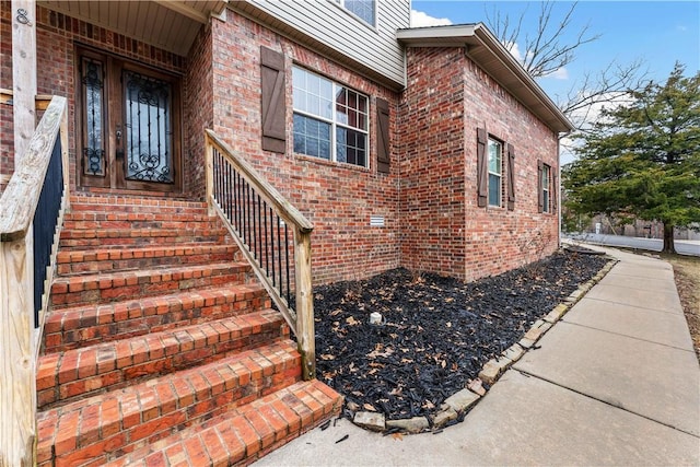 property entrance featuring brick siding