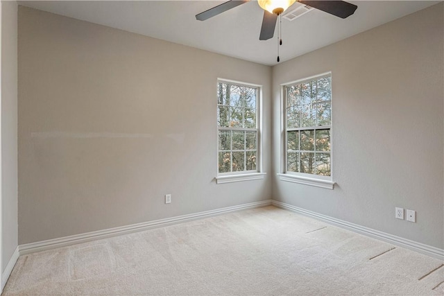 unfurnished room featuring carpet, a ceiling fan, and baseboards