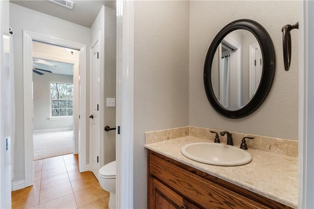 bathroom featuring tile patterned floors, toilet, and vanity