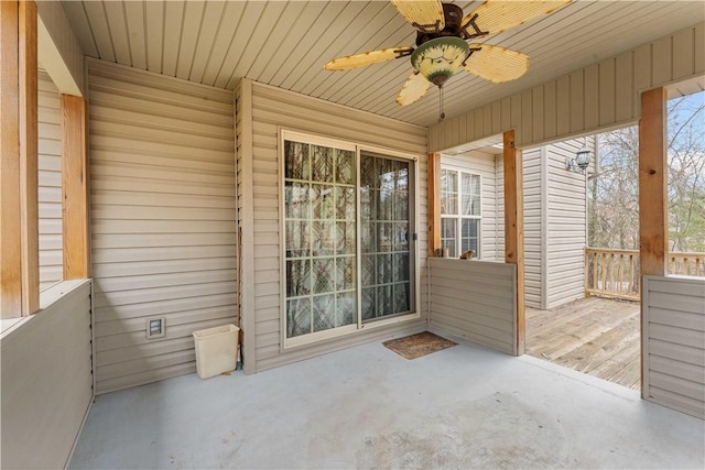 unfurnished sunroom with a ceiling fan