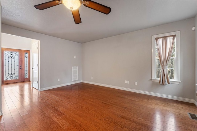 spare room with ceiling fan and hardwood / wood-style floors