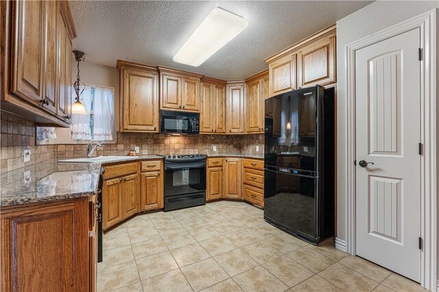 kitchen with black appliances, a sink, a textured ceiling, backsplash, and light tile patterned flooring