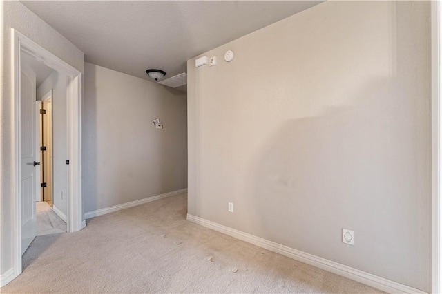spare room with carpet floors and baseboards