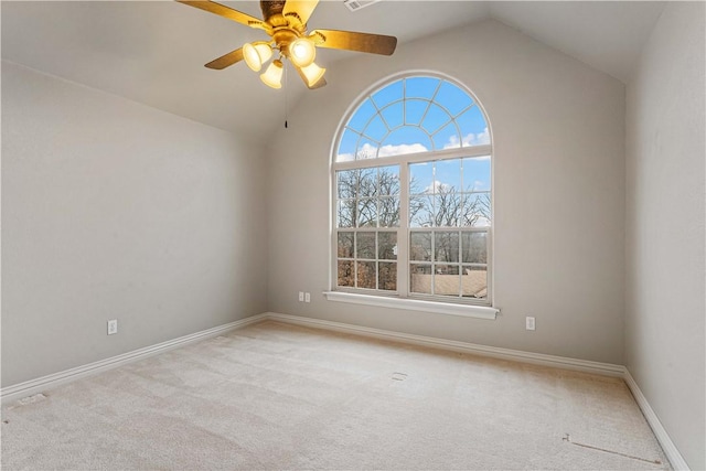 unfurnished room with vaulted ceiling, a ceiling fan, carpet flooring, and baseboards