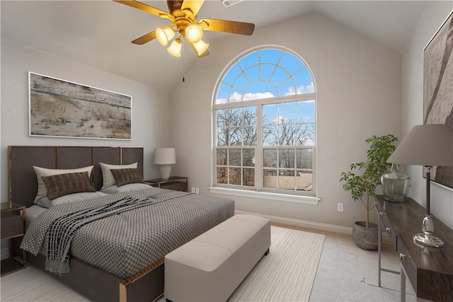 carpeted bedroom featuring vaulted ceiling, ceiling fan, and baseboards