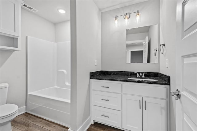 full bathroom featuring vanity, tub / shower combination, and toilet