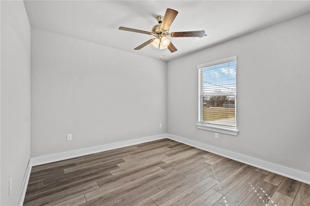 empty room featuring hardwood / wood-style floors and ceiling fan