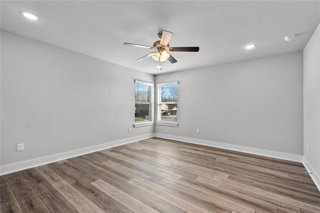 spare room with ceiling fan and light wood-type flooring