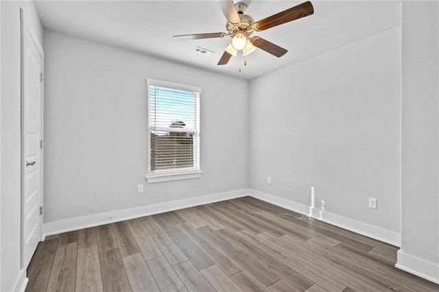 empty room featuring wood-type flooring and ceiling fan