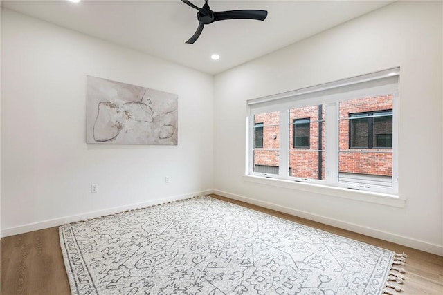 empty room with light wood-type flooring and ceiling fan