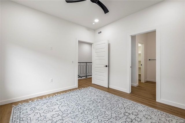 unfurnished bedroom with ceiling fan and wood-type flooring