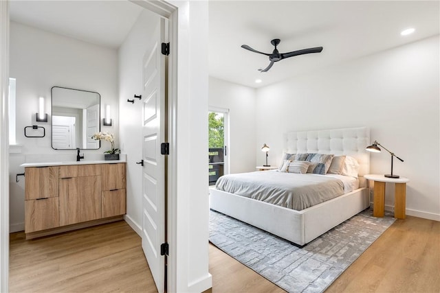 bedroom with ceiling fan, light hardwood / wood-style flooring, sink, and access to exterior