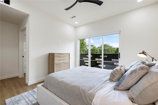 bedroom with light hardwood / wood-style floors, ceiling fan, and access to exterior