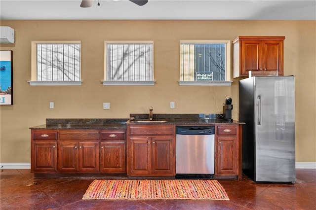 kitchen featuring ceiling fan, appliances with stainless steel finishes, dark tile patterned flooring, and sink