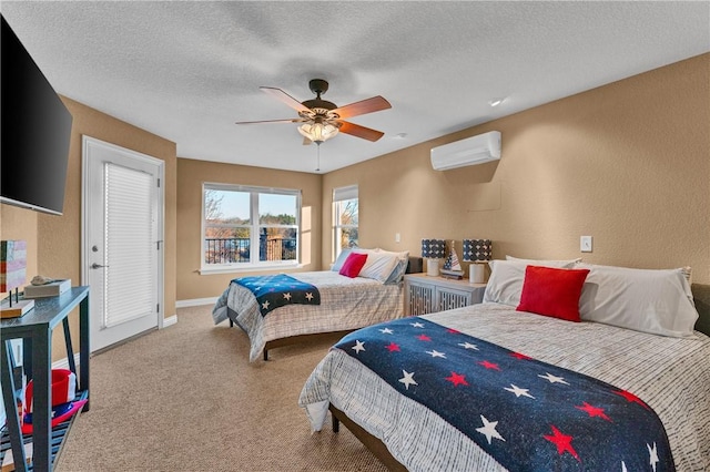 carpeted bedroom featuring ceiling fan, a wall mounted AC, and a textured ceiling