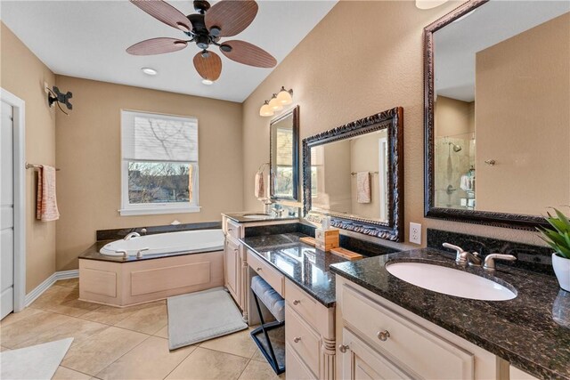 bathroom with independent shower and bath, vanity, tile patterned flooring, and ceiling fan