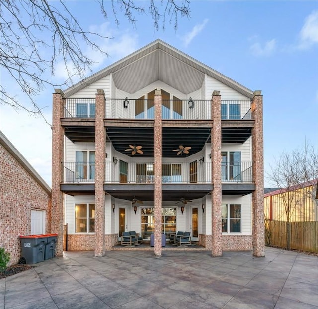 back of house featuring ceiling fan and a balcony