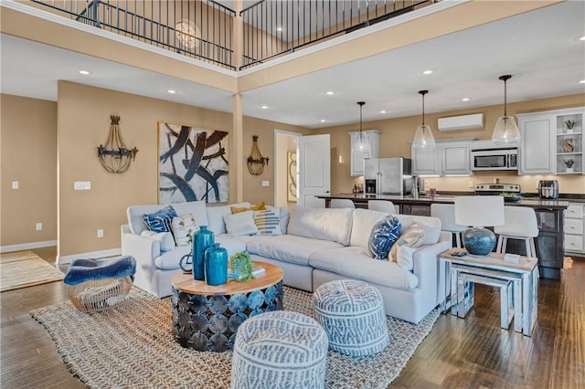 living room with a towering ceiling, dark hardwood / wood-style floors, and sink