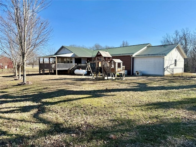 exterior space with a playground and a front yard