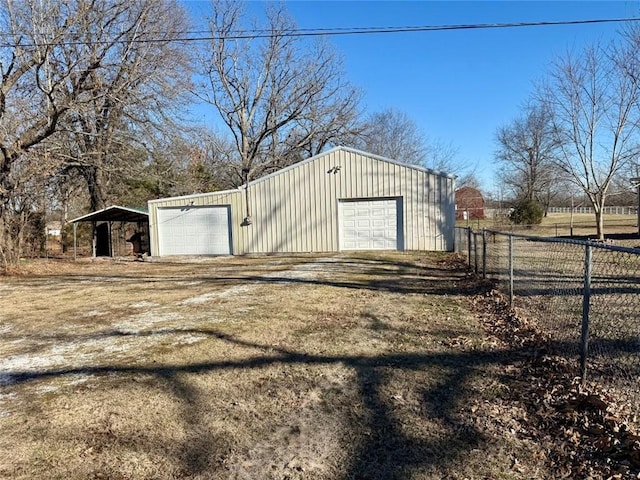 view of outbuilding with a carport and a garage