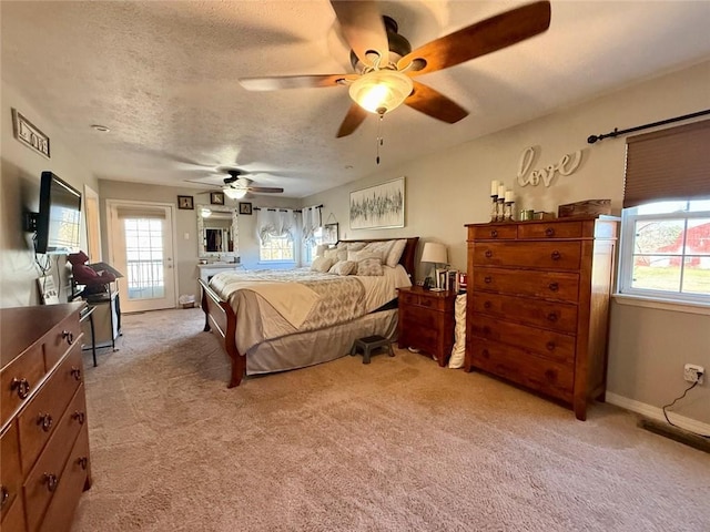 carpeted bedroom with a textured ceiling and ceiling fan