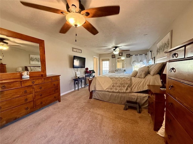 bedroom with ceiling fan, light colored carpet, and a textured ceiling