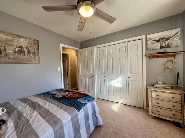 bedroom with light colored carpet, a closet, and ceiling fan