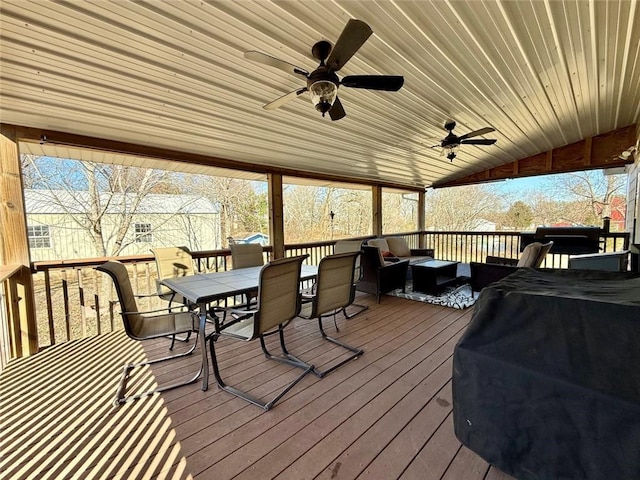 wooden deck with grilling area and ceiling fan