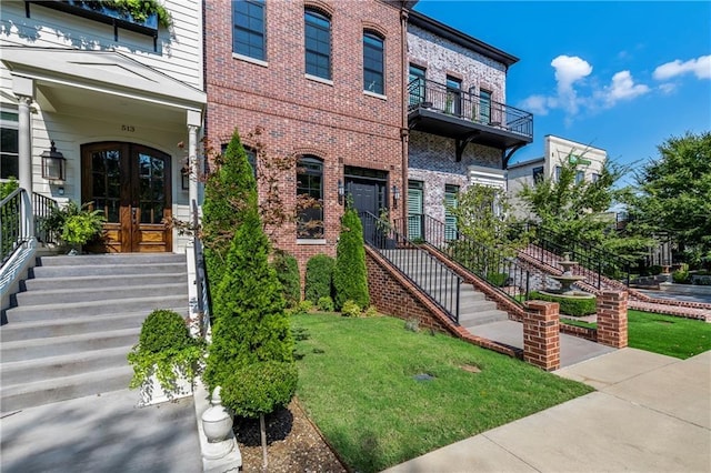 exterior space with a lawn and french doors