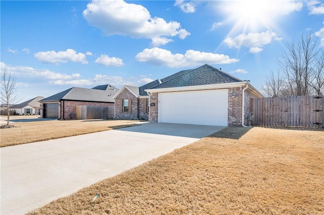 ranch-style house featuring a garage and a front lawn