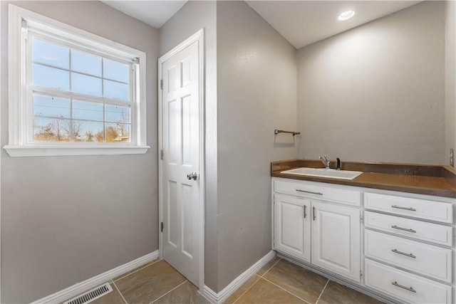 bathroom with visible vents, tile patterned floors, vanity, and baseboards