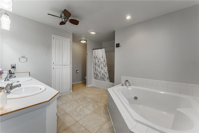 bathroom with double vanity, a sink, toilet, and a bath