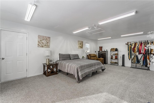 bedroom featuring attic access and carpet flooring