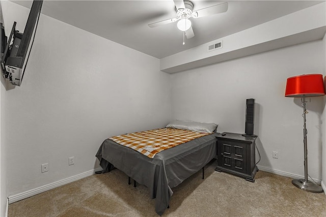 bedroom featuring visible vents, baseboards, a ceiling fan, and light colored carpet