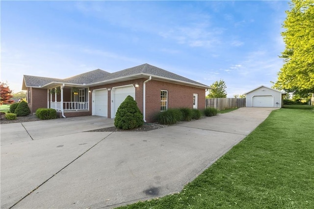 view of home's exterior featuring brick siding, a yard, covered porch, an attached garage, and driveway