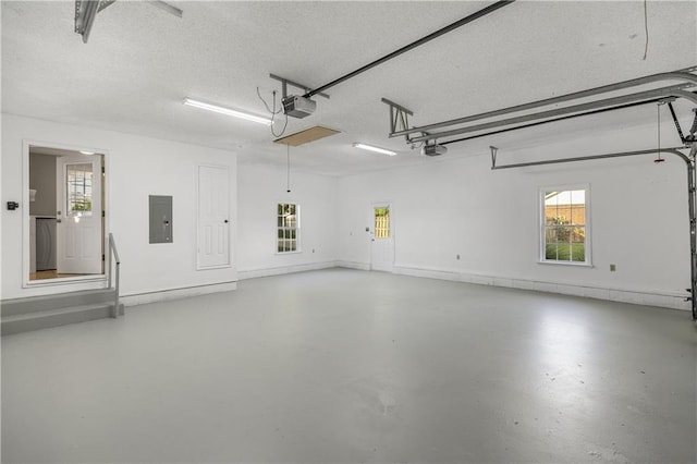 garage with electric panel and a garage door opener