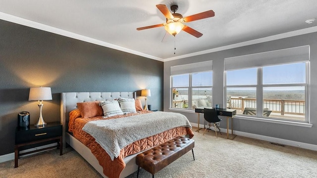 carpeted bedroom with crown molding and ceiling fan