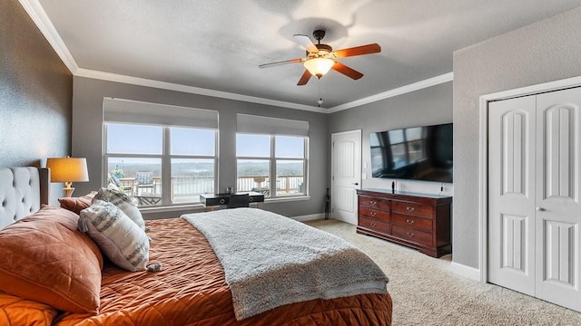 carpeted bedroom with crown molding and ceiling fan